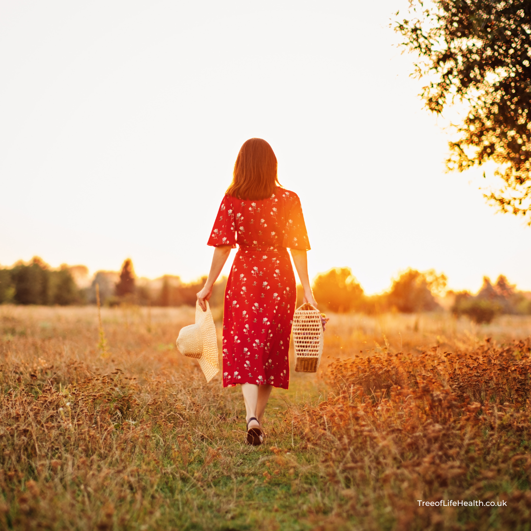 imageof lady in red dress wallking through field experiecing ABC™ Benefits from Advanced Biostructural Correction™ at TreeofLifeHealth.co.uk