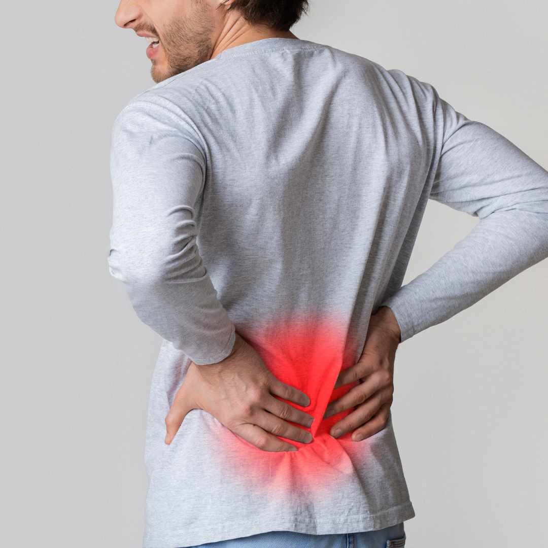 image of man holding back due to low back pain.